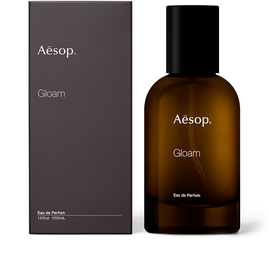 An amber bottle of Gloam Eau de Parfum alongside carton packaging. 