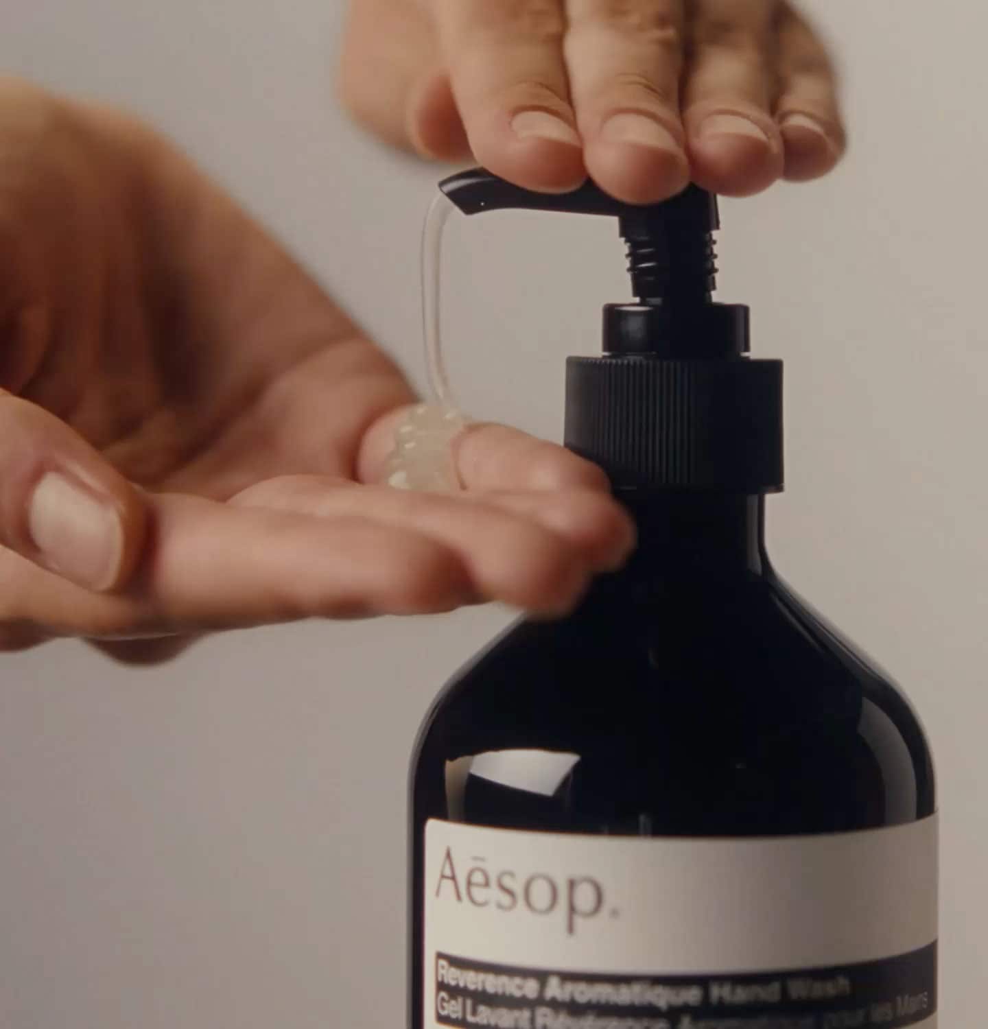 Hands dispensing reverence aromatique hand wash