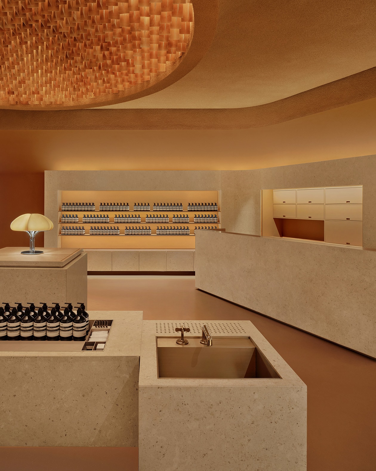 Aesop Haitang Bay interior featuring a warm color palette, while a sink is integrated into the counter design. 