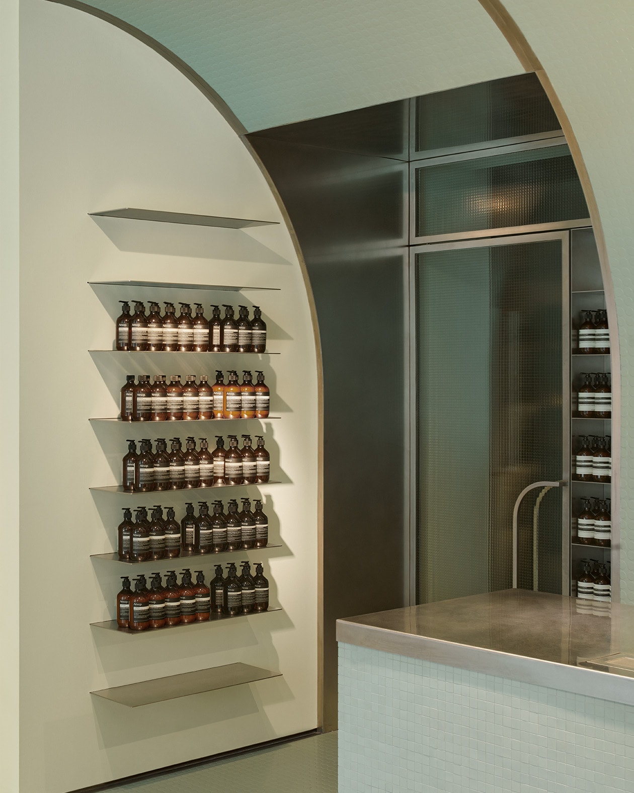 Aesop Milano Cordusio store interior product display on metal shelving.