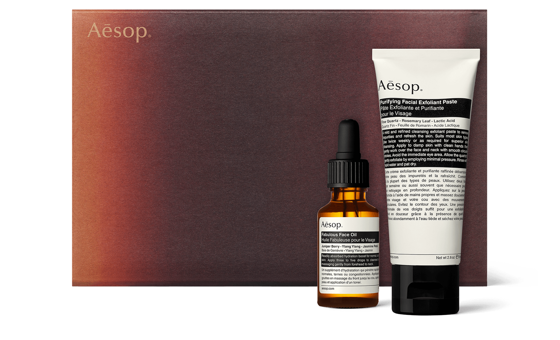 A facial exfoliant and oil alongside a recycled cardboard gift box.