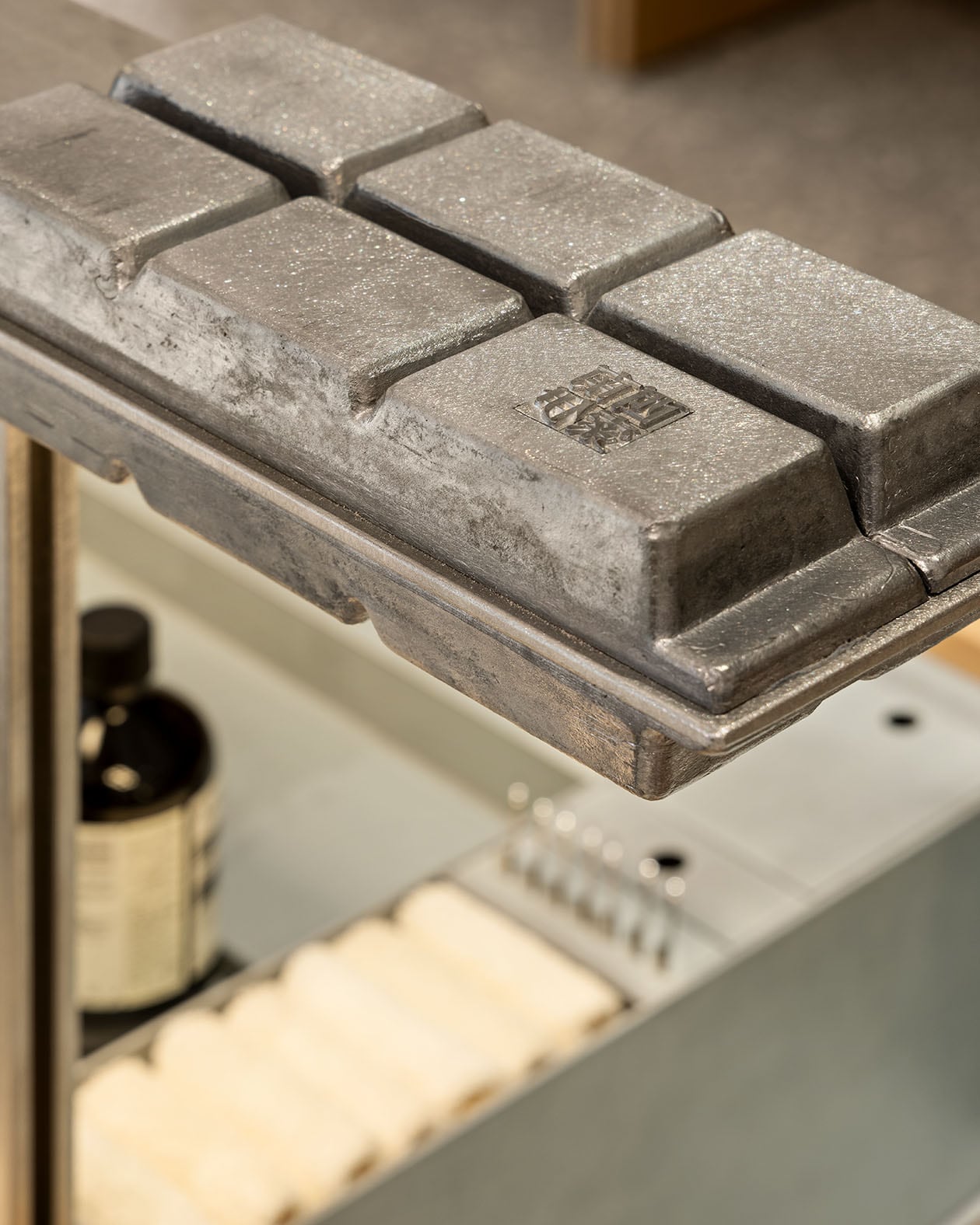Mimicking the material and inclined form of the shelves in the foundry,  displaying the finished type blocks.
