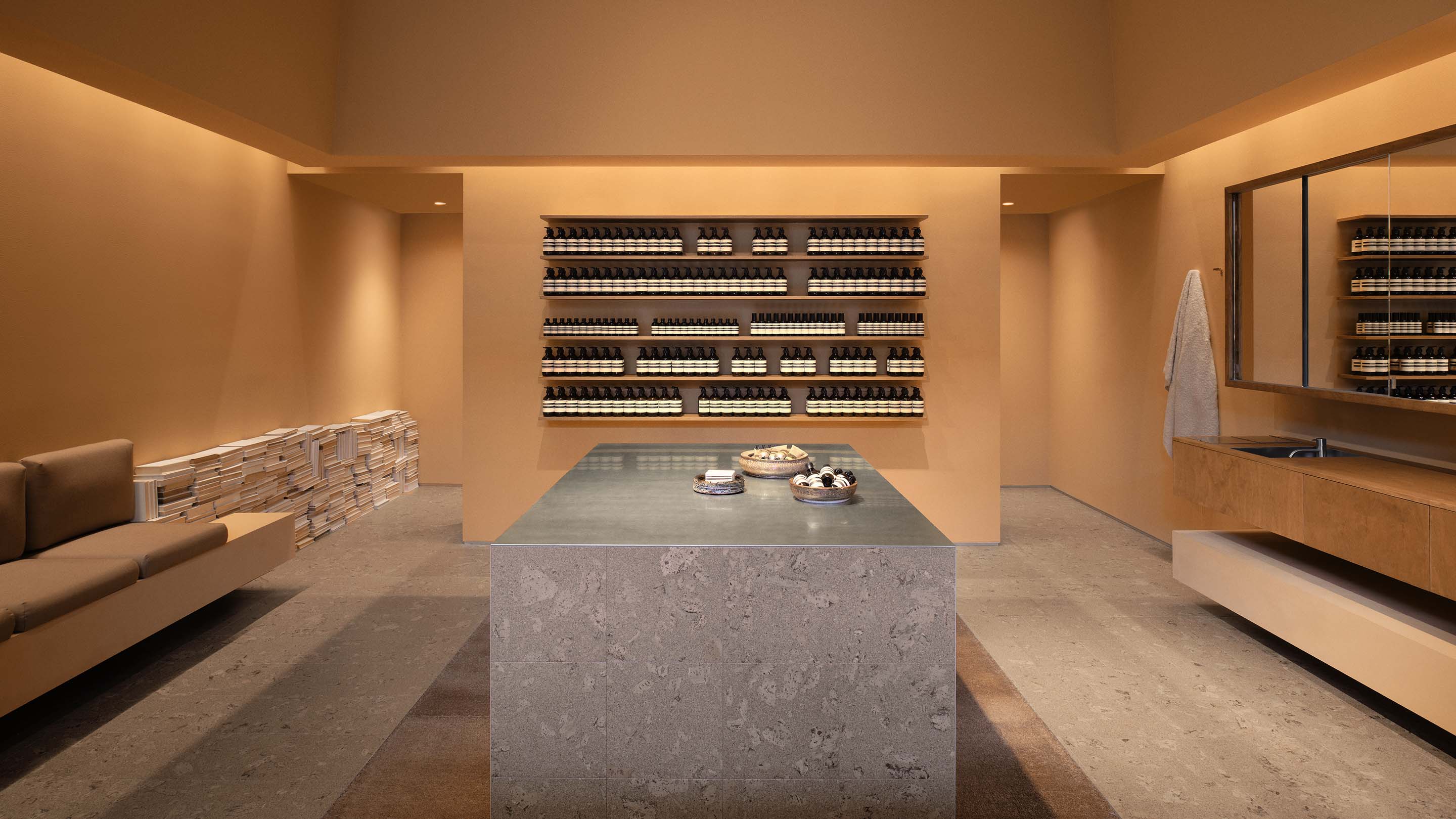 The store interior featuring marble counter top and wooden shelves with products.