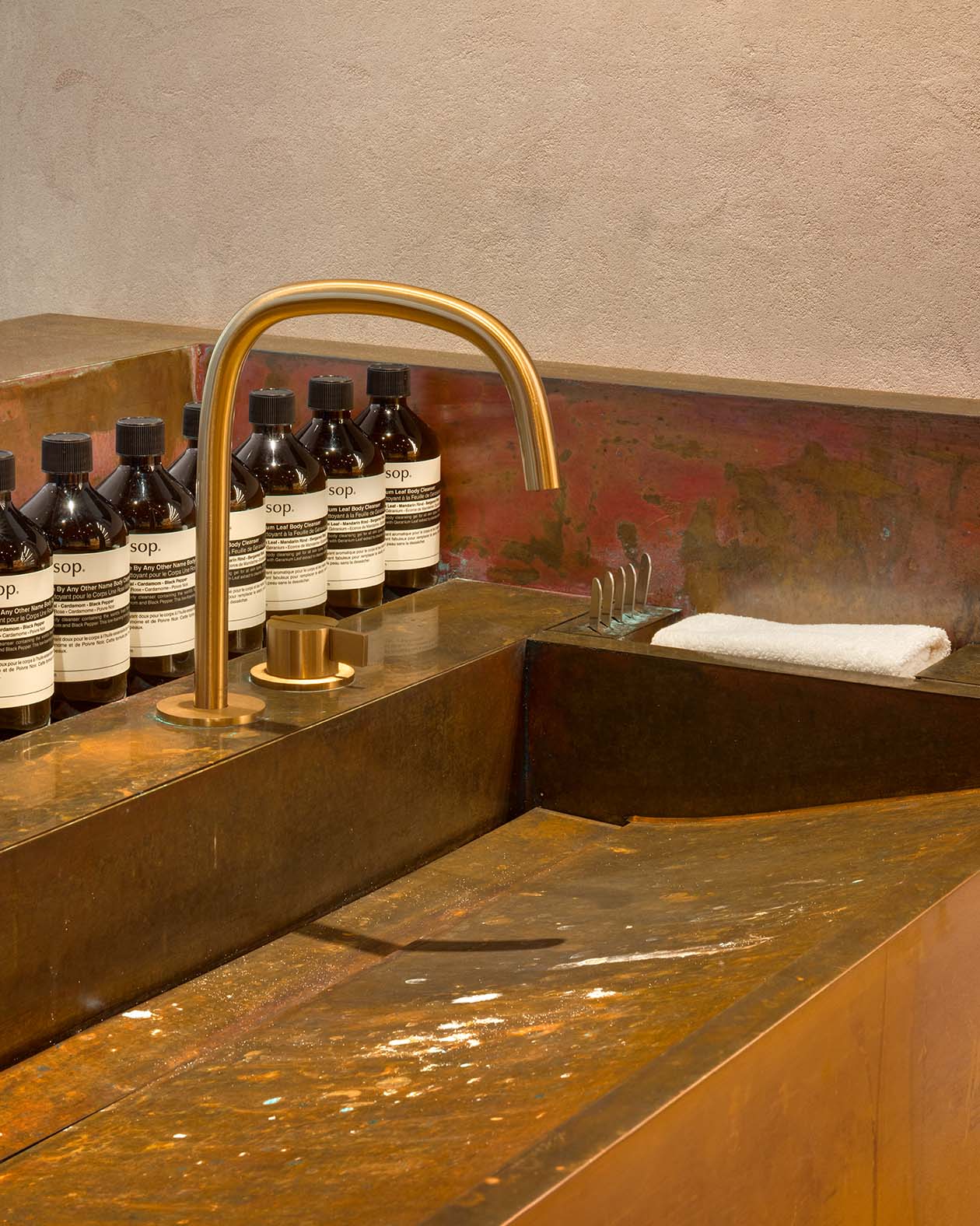 copper basin with faucet and product in the background