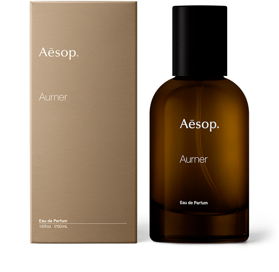 An amber glass bottle of Aurner Eau de Parfum alongside brown carton packaging.