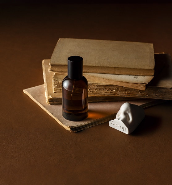 A fragrance next to some books