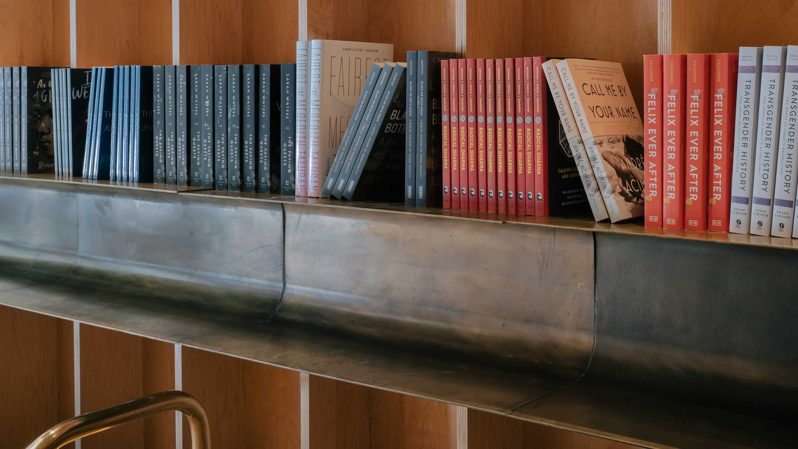 A store installation of Queer literature displayed on the shelves.
