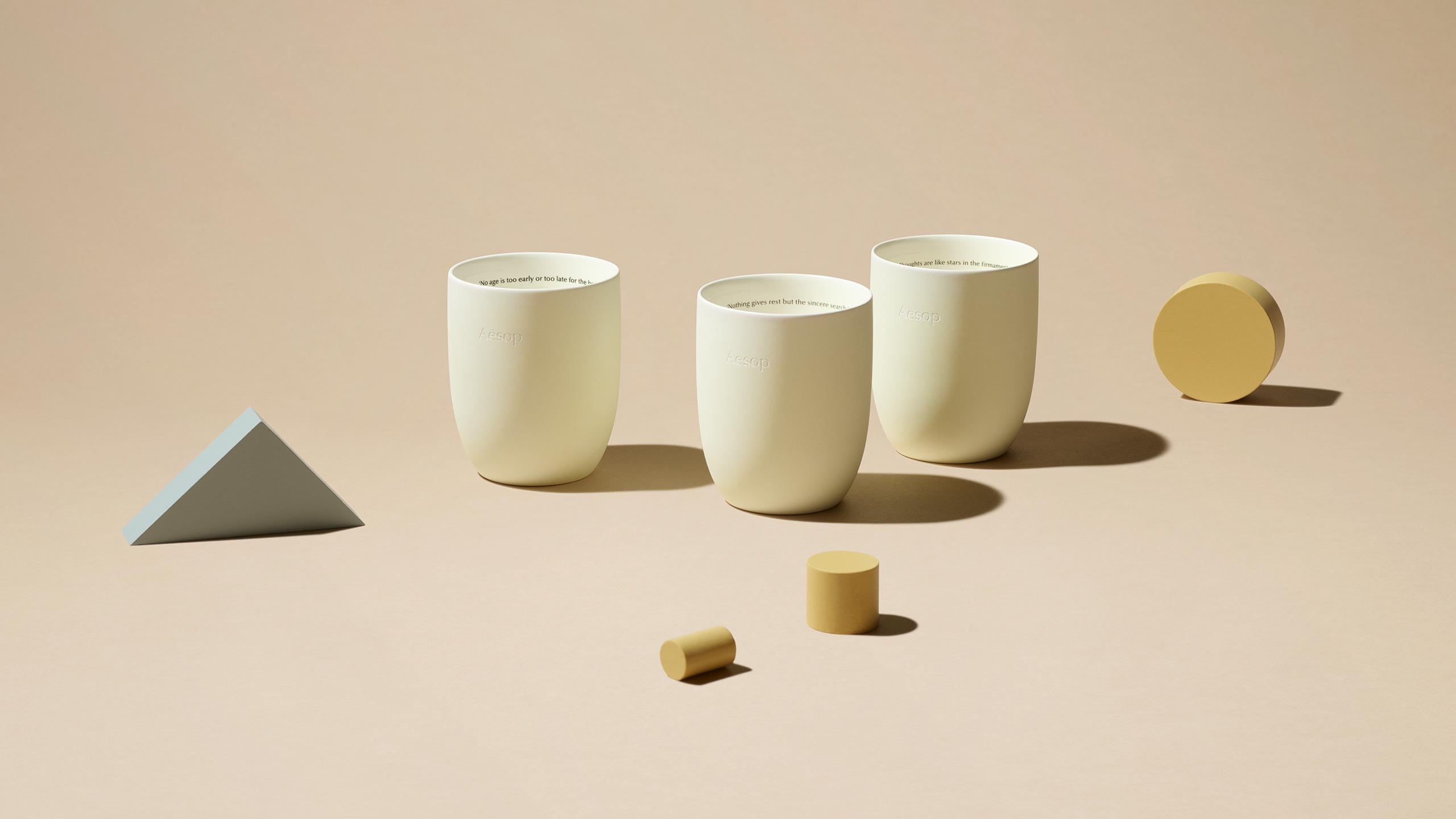 Aromatique Candles in front of geometric blocks