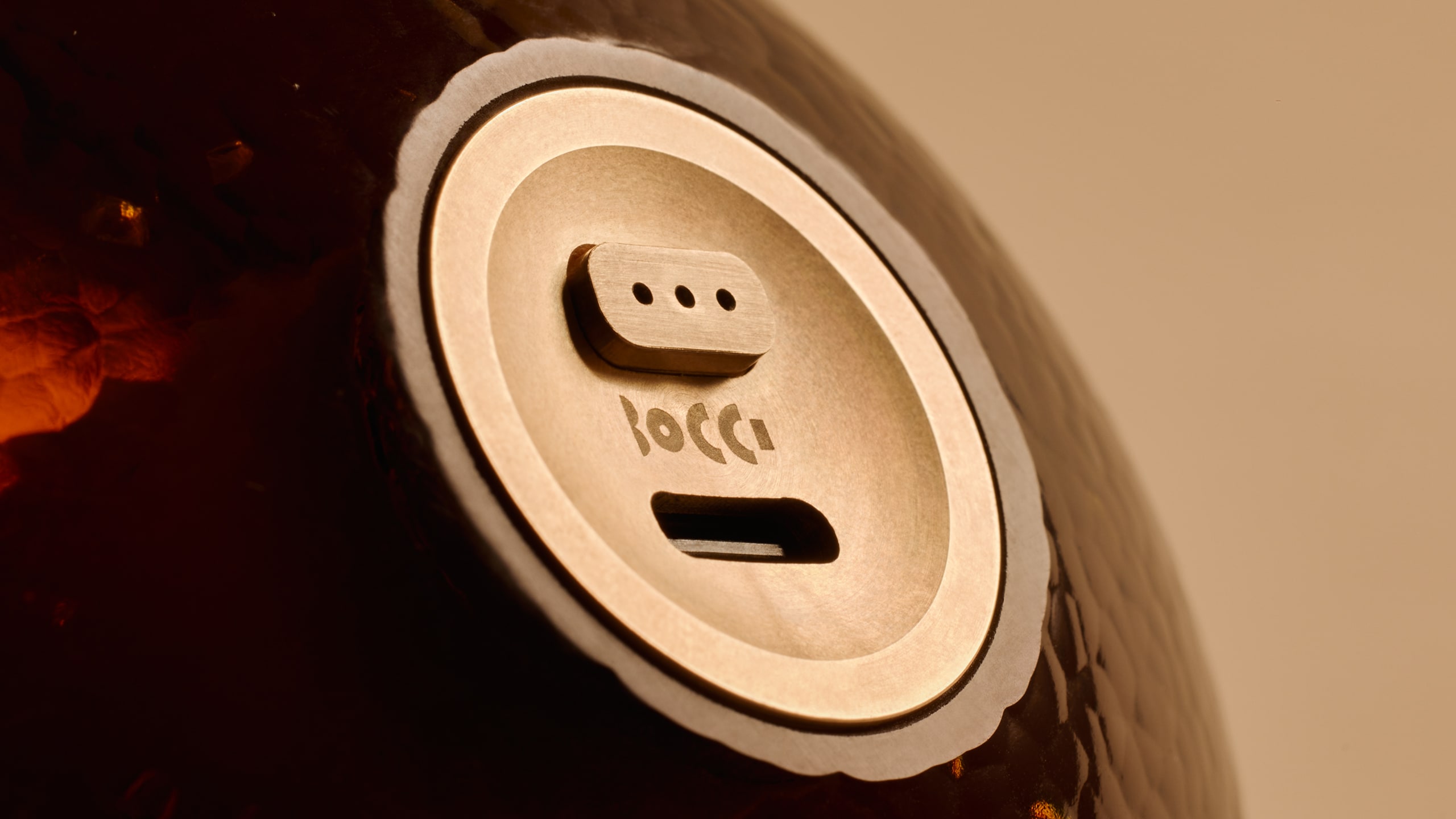 detail shot of Bocci 14p lamp power button and charging port, featuring engraved Bocci logo