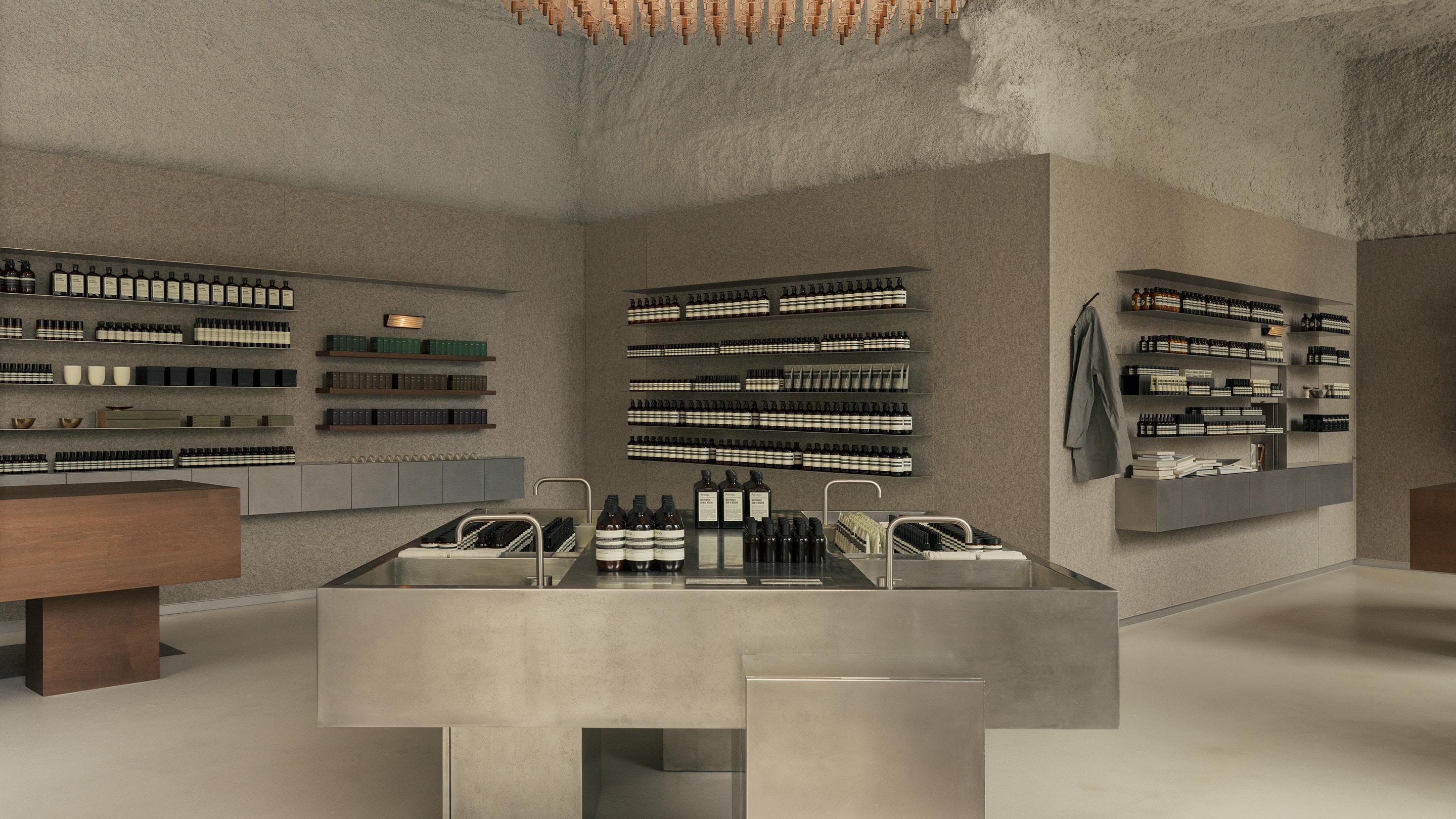 Aesop Aesop Lyon Place de la Republique store interior featuring the large central metal basin and product displays of amber bottles.