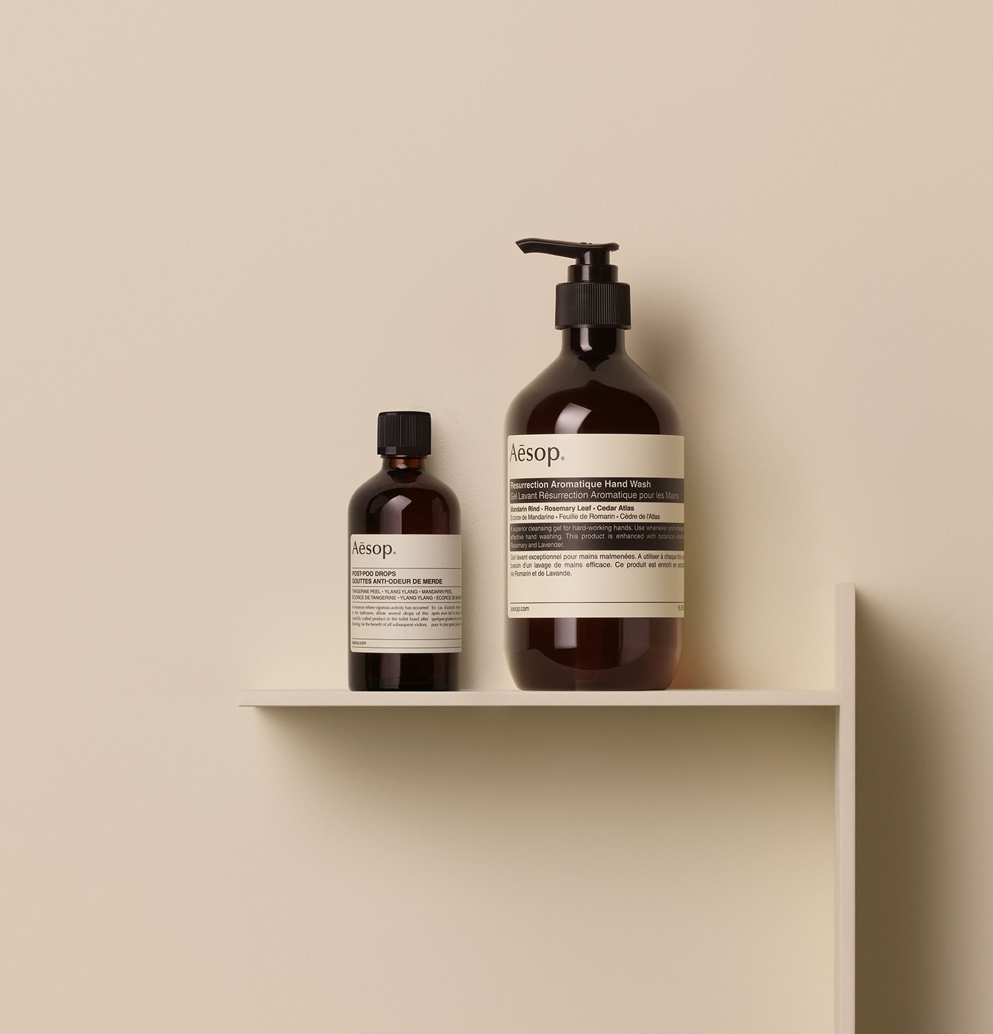 Aesop Post-Poo Drops and Resurrection Hand Wash Products placed together on a shelf