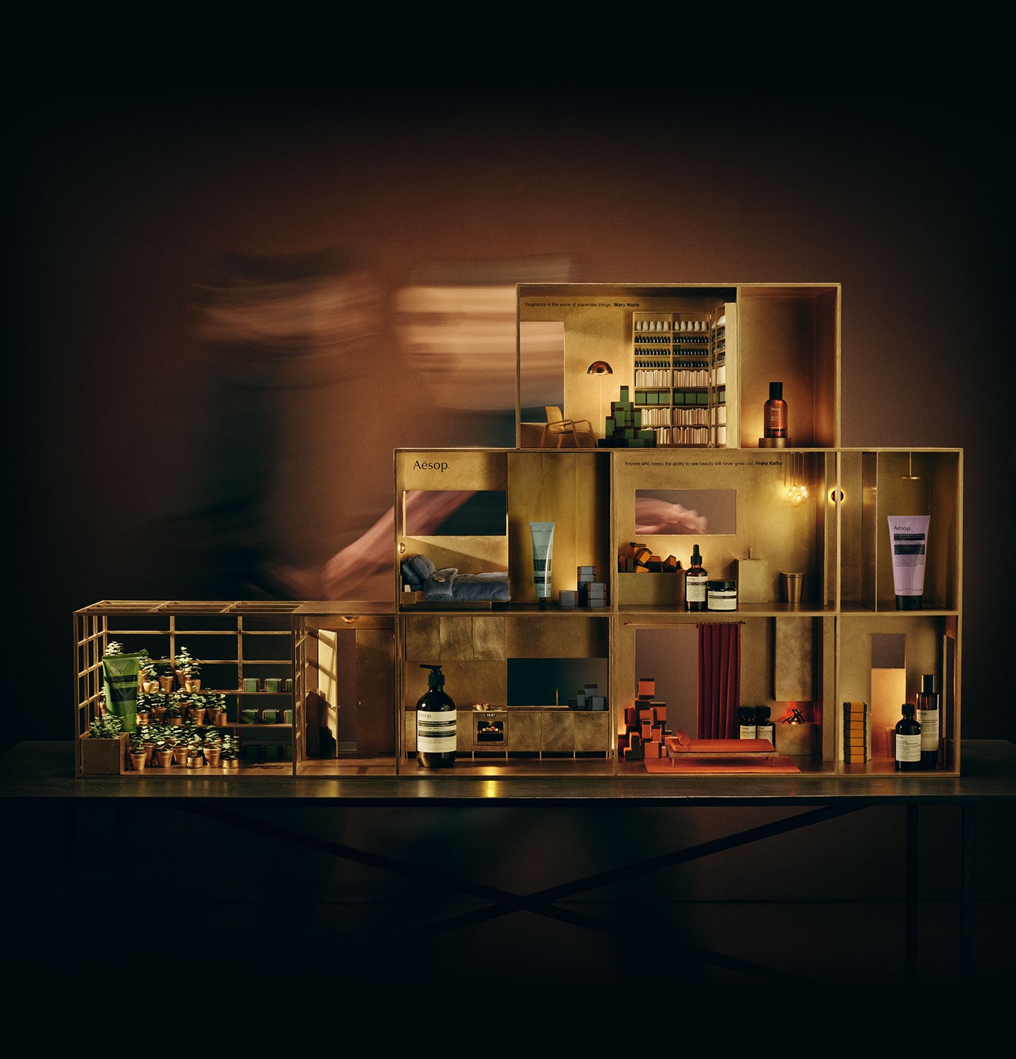 Festive miniature brass dolls house featuring a variety of Aesop products in every room.