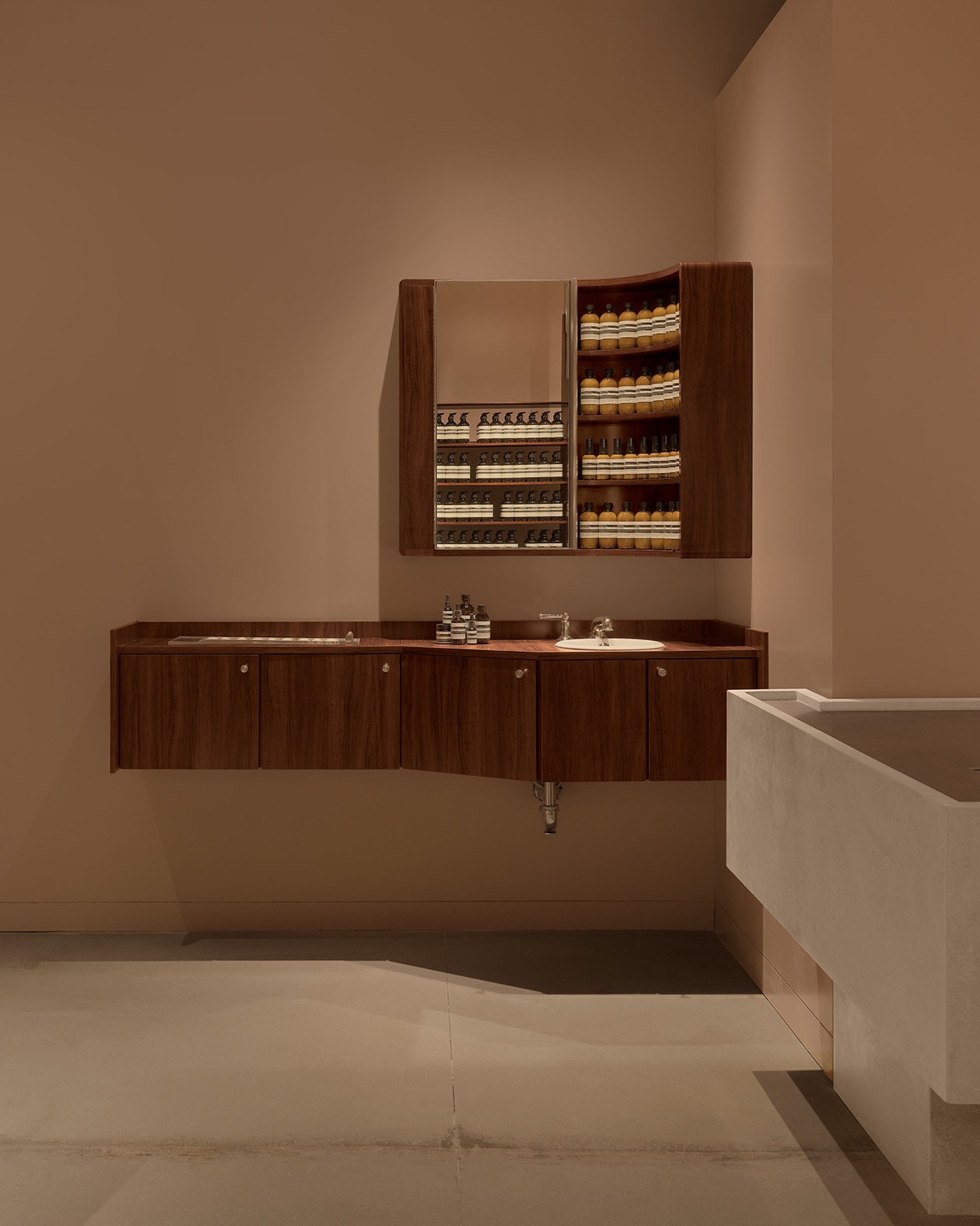 store interior featuring concrete floor and small wooden basin unit in corner