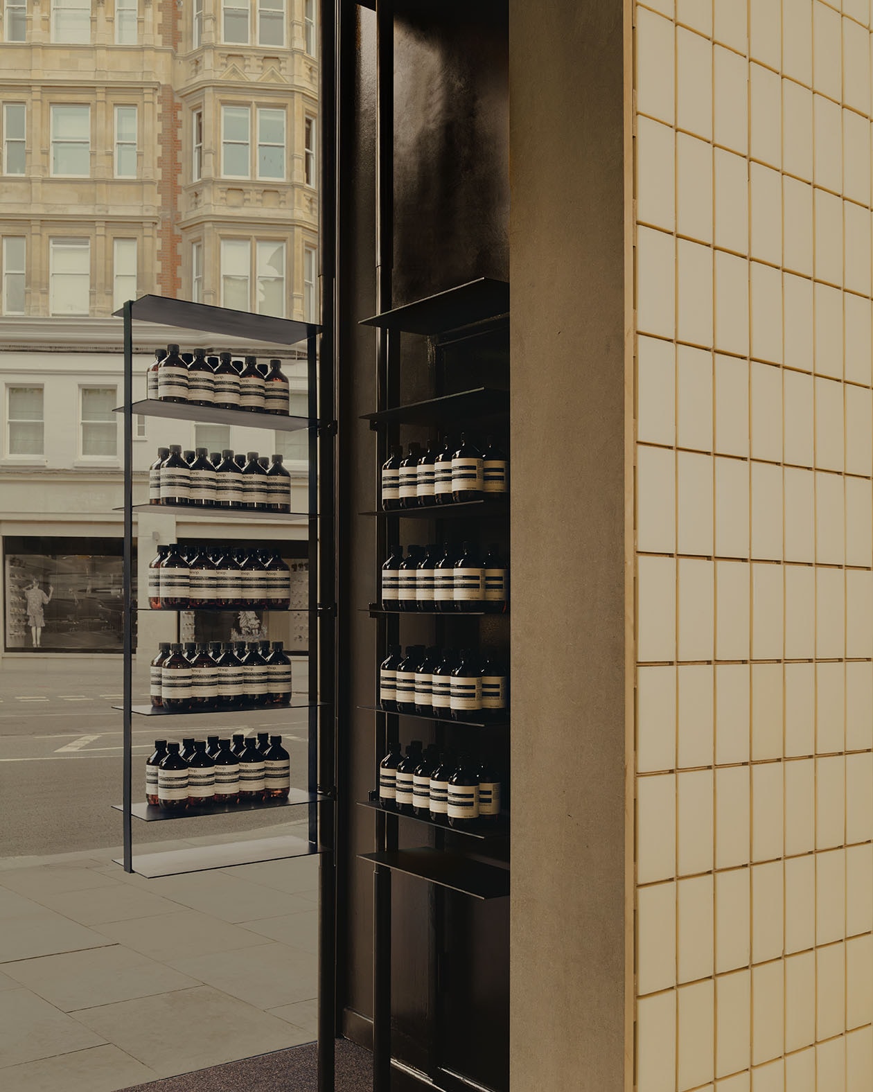 Aesop Knightsbridge store interior window display case with products featured in amber bottles.