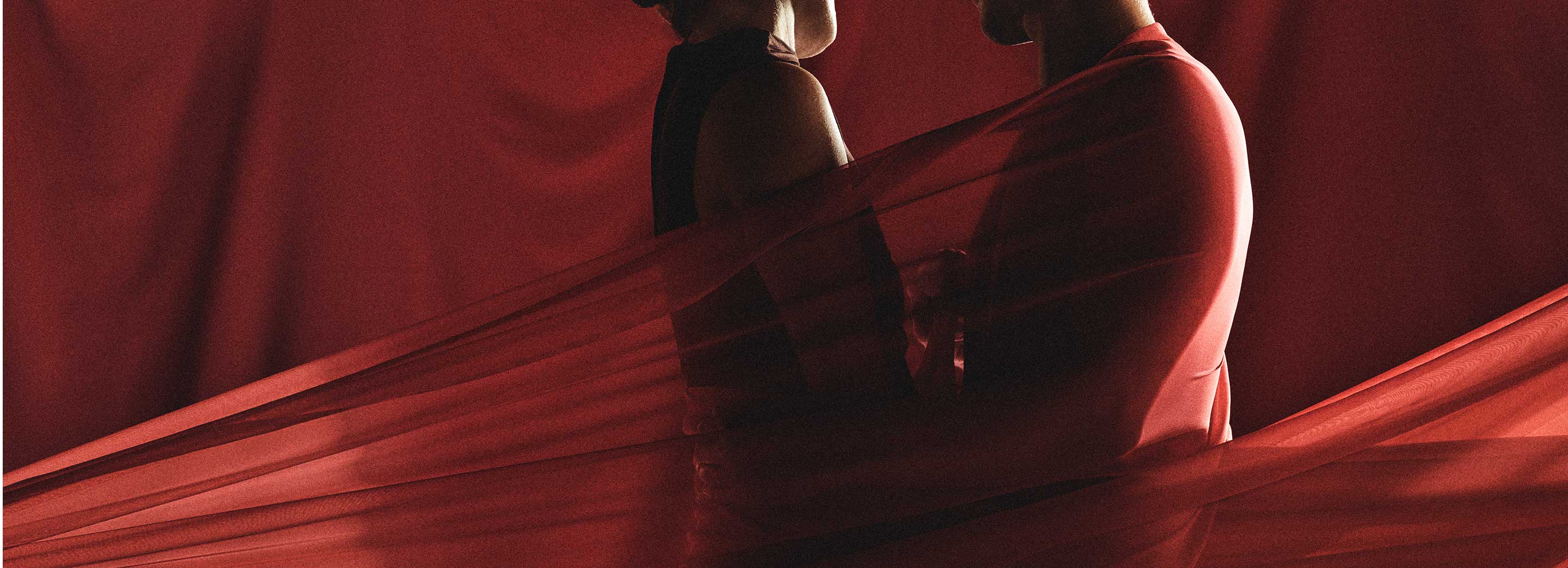 A couple in close proximity in a Valentines Day theme.