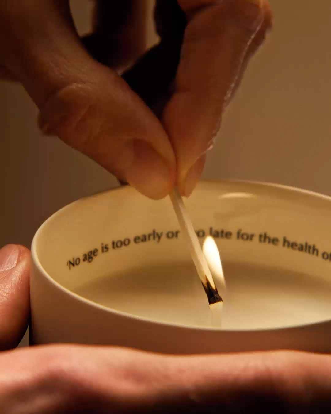 Aesop candle being lit.